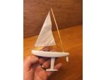 The white-hulled mini-Marblehead has astern stepped mast. Okay, it looks unusual, but it works!