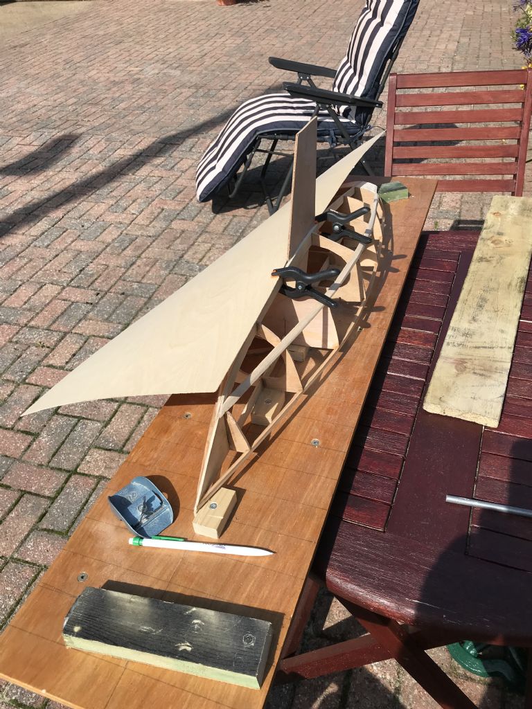 fitting the sheet around keel.jpg fitting the sheet around keel.jpg